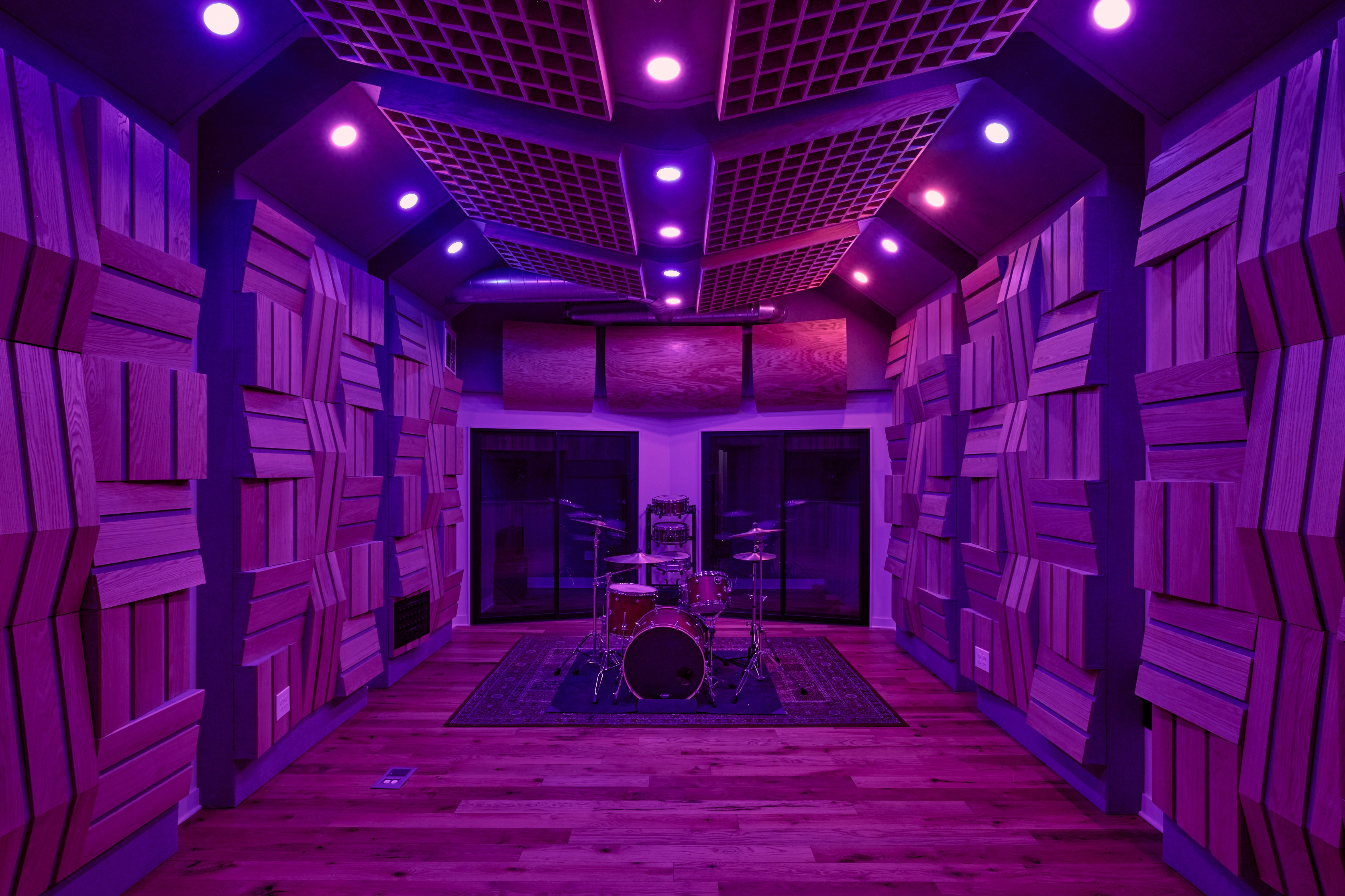 Live room with drum set and dark lighting.